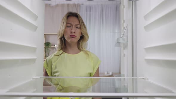 View From Inside of an Empty Refrigerator While Cleaning