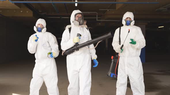 Happy Medical Workers Wearing Biological Protective Suit Goggles and Respirator Dancing and Have Fun