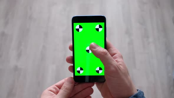Male Using Smartphone  with Green Screen in Home