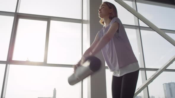 Woman Spreading Yoga Mat