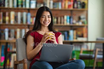 Lady Posing With Laptop And Coffee In Cafe, Looking At Camera, Free Space