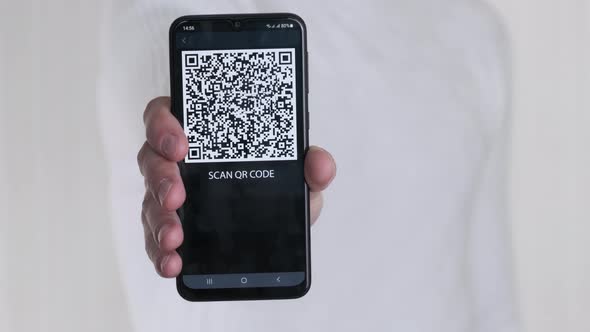 Male Hand Shows QR Code on Smartphone on White Background