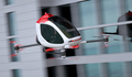 Electric Passenger Drone flying in front of buildings - PhotoDune Item for Sale