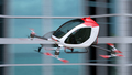 Electric Passenger Drone flying in front of buildings - PhotoDune Item for Sale