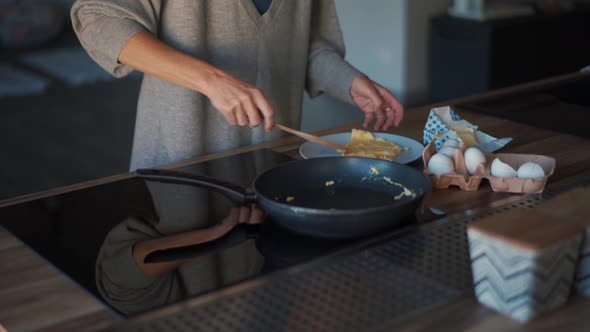 Woman including oven after cooking omelet