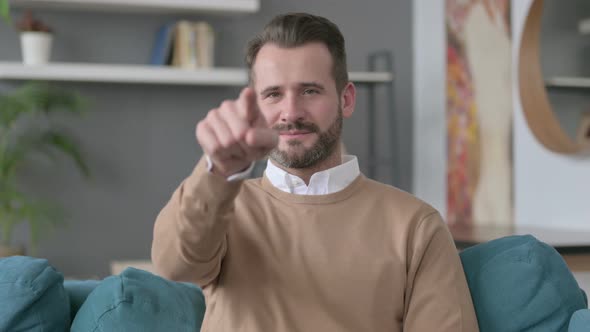 Portrait of Man Pointing Towards Camera