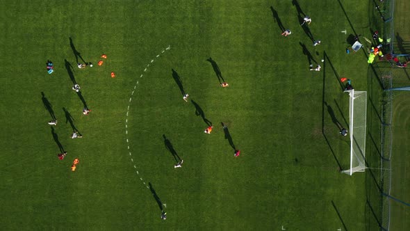 Top View of a Sports Football Field with Players Playing Football