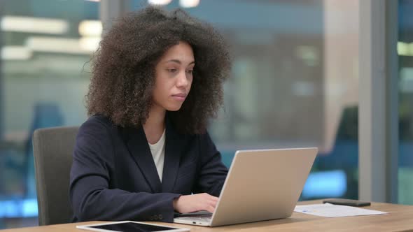 African Businesswoman Using Laptop with Thumbs Up Sign