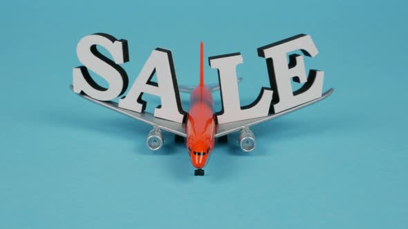 Orange Plane Moves to Camera on Wings with Inscription Sale. Stop Motion Animation 