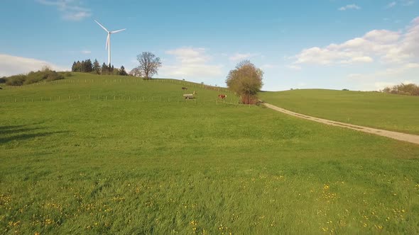 Wind turbine on a green hill in the mountains