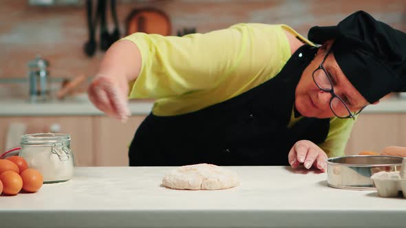 Woman is Occupied with Dough Preparation