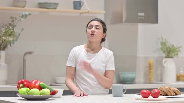 Young Indian Woman Feeling Worried While Standing in Kitchen