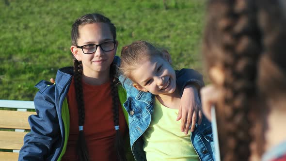 A Group of Children Sitting on a Bench.