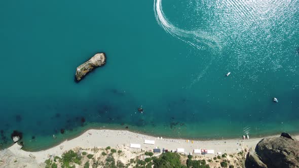 Aerial View From Above on Calm Azure Sea and Volcanic Rocky Shores