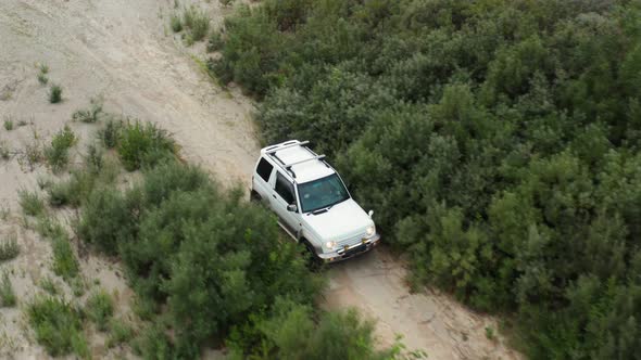 Aerial View of a Car Driving on Sand