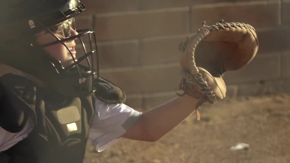 A boy plays catcher in a little league baseball game.