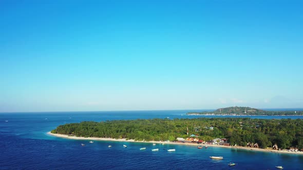 Aerial drone shot panorama of tranquil resort beach adventure by blue green lagoon with white sand b