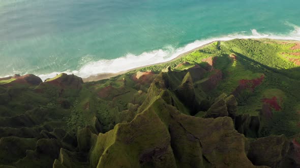 Cinematic Aerial Beautiful Green Ocean Coast with Amazing Green Peaks at Sunset