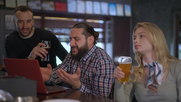 Anxious Man Working Online on Laptop Meeting with Friend in Pub on Weekend