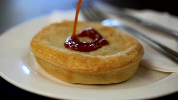 Meat Pie Topped with Tomato Sauce