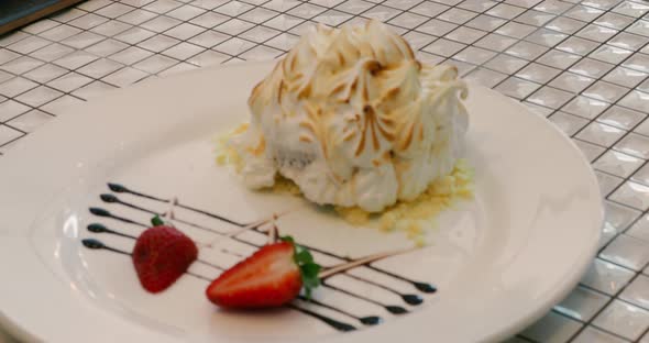 Closeup of Delicious dessert of cream and strawberries on a checkered table
