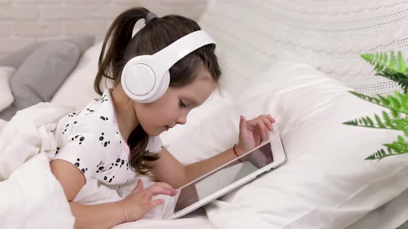 Little Child Baby Girl Listening To the Music with Headphones