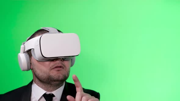 A Man in a Black Suit Uses Virtual Reality Goggles