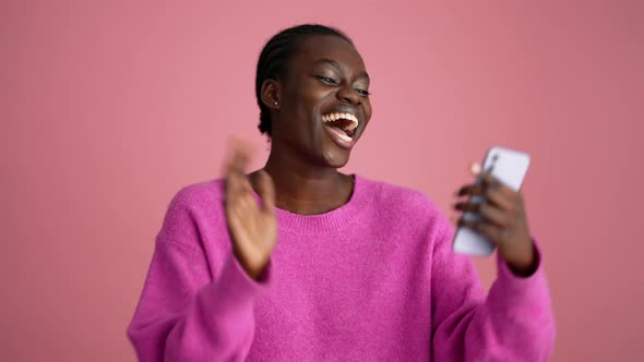 Happy blonde woman hippie texting by phone