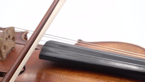 Violin in Female Hands, Getting Played By the Woman at White Background. Close Up of Bow and Strings