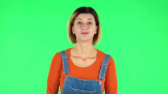 Woman in Anticipation of Worries, Then Guilty Hides His Eyes. Green Screen