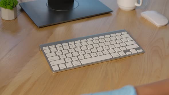 Hands in Protective Latex Gloves Sprays an Antiseptic on the Keyboard Surface and Thoroughly Cleanse