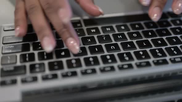 Close Up of African Woman Hands Typing on Laptop