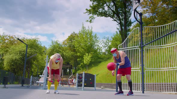 Active Senior Man Woman Playing Basketball Outdoors on Sports Playground Court During Coronavirus