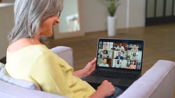 Grayhaired Senior Woman Using Online Platform for Online Communication with Colleagues