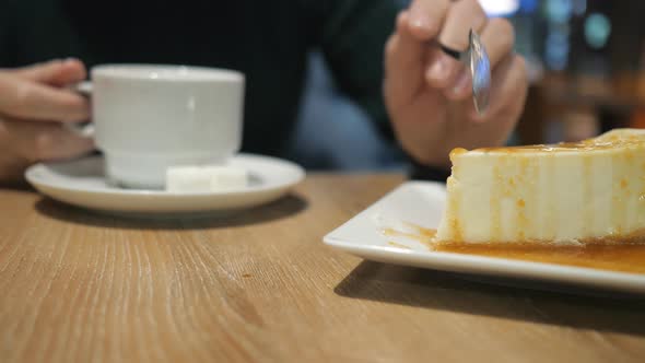 Unknown Girl with Cup of Beverage Eating Cake at Cafe