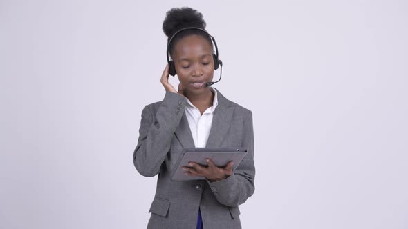 Young Stressed African Businesswoman As Call Center Representative Using Digital Tablet