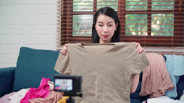 Asian stylist fashion influencer designer women using camera streaming and live to sell clothes