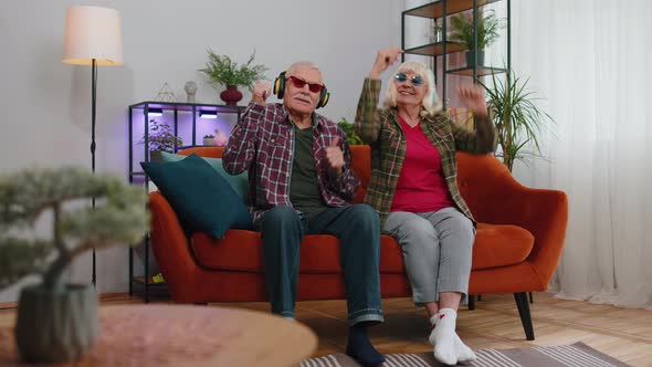 Happy Senior Grandparents Man Woman Listening Music Dancing Disco Fooling Around Having Fun at Home