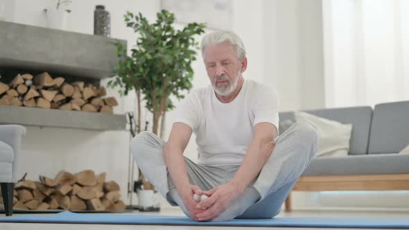 Old Man Doing Stretches on Yoga Mat at Home