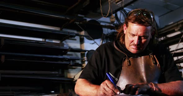 Welder working on blueprint