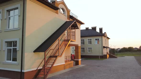 Footage of modern daycare school building with emergency fire exit staircase.