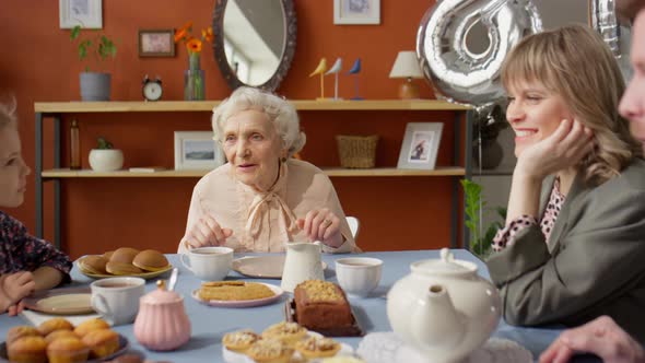 Grandma Talking with Family on Birthday Dinner