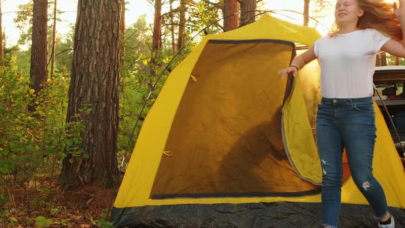 Tourist Family Waking Up Inside Camping Tent in Sunny Forest. Happy Family on Background Morning