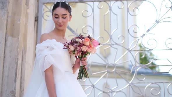 Bride Holds Beautiful Wedding Bouquet Before Her Face