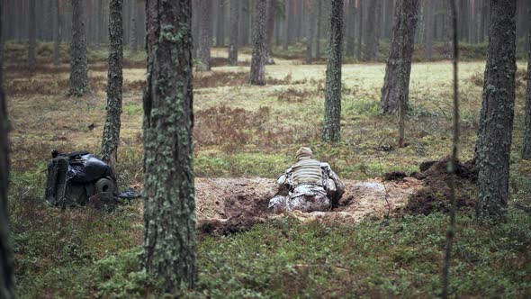 One Soldier Digs a Trench in a Pine Forest