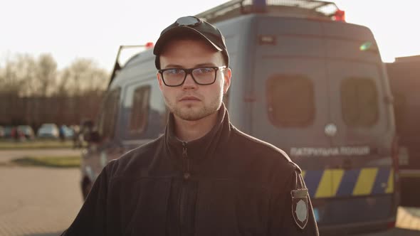 A Man in a Police Uniform is Looking Seriously at the Camera