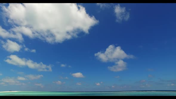 Aerial top down panorama of marine coastline beach trip by blue water with white sandy background of
