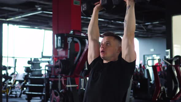 Muscular Man is Engaged in the Gym