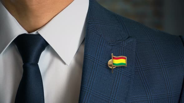 Businessman Walking Towards Camera With Country Flag Pin Bolivia