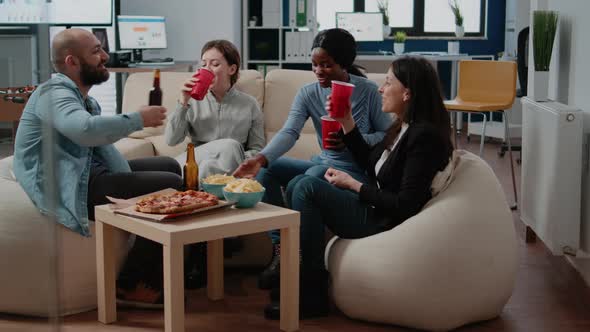 Diverse Group of Workers Clinking Cups and Bottles of Beer